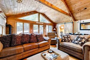 a living room with two couches and a table at Sunday River Sunny Chalet in Bethel