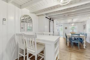a white dining room with a white table and chairs at Long Sands Serenity in York