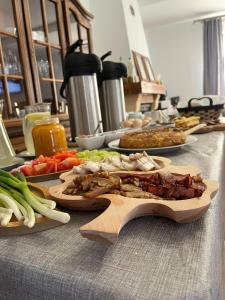 a table topped with plates of food and vegetables at Casa OLD BRICK in Ocna Şugatag