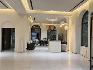 a lobby with a bar in the middle of a building at Ammar Hotel in Dushanbe +54 photos