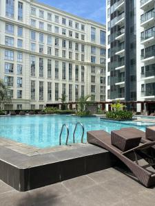 a swimming pool in front of a building at Resorts World Eighty One Newport Boulevard Near Airport T2 and T3 in Manila