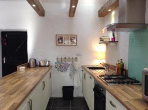 a kitchen with white counters and a stove top oven at Hillside Cottage Achill in Achill Sound