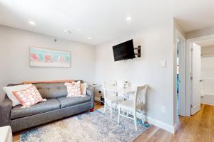 a living room with a couch and a table at 204 at the Shore in Wells