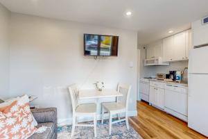 a living room with a table and chairs and a kitchen at 204 at the Shore in Wells