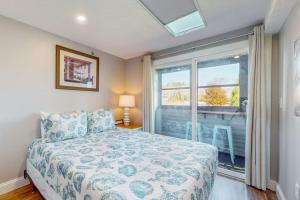a bedroom with a bed and a large window at 204 at the Shore in Wells +48 photos