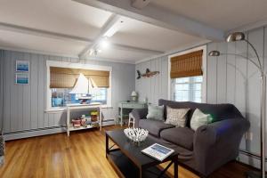 a living room with a couch and a table at Sea La Vie in York