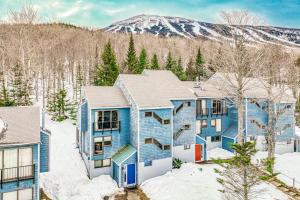 an aerial view of a blue house in the snow at Sugarloaf Mountain Treasure in Carrabassett
