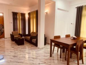 a living room with a table and a couch at Anchorage Apartment in Kurunegala
