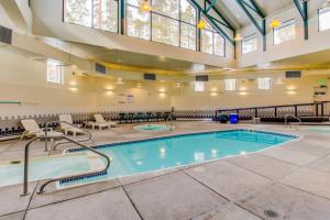 a pool in a large room with a large ceiling at Lodgepole Landing in Silverthorne
