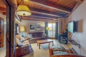 a living room with a couch and a tv at Lodgepole Landing in Silverthorne