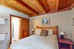 a bedroom with a large bed and wooden ceilings at Lodgepole Landing in Silverthorne +53 photos