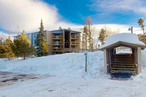 a building in the snow with a ramp and stairs at Lodgepole Landing in Silverthorne
