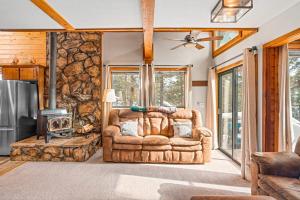 a living room with a couch and a fireplace at The Better House in Vallecito