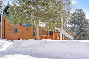 a house with an orange fence in the snow at The Better House in Vallecito