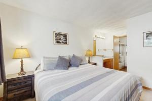 a bedroom with a large bed and a bathroom at East Bay 6 in Dillon