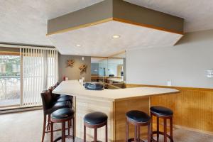 a kitchen with a large island with stools at East Bay 6 in Dillon