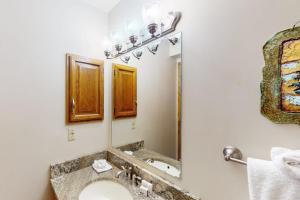 a bathroom with a sink and a mirror at Buffalo Village 402 in Silverthorne +41 photos