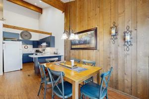 a kitchen and dining room with a wooden table and chairs at Pines 4031 in Pagosa Springs