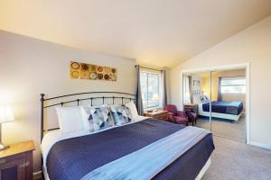 a bedroom with a king sized bed and a living room at Pines 4058 in Pagosa Springs