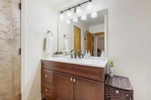 a bathroom with a sink and a large mirror at Pines 4031 in Pagosa Springs +19 photos