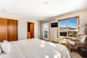 a bedroom with a large bed and a large window at Twenty Grand Chalet in Silverthorne