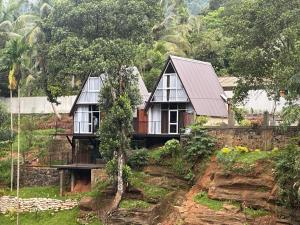 a house sitting on top of a hill at Kithulgala Cabana Resort in Kitulgala