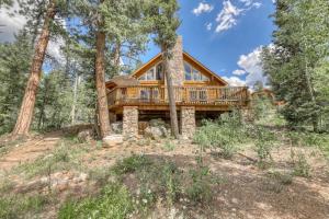 a log home with a deck in the woods at Heaven's Gate in Durango