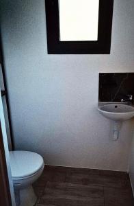 a bathroom with a toilet and a sink at La maison du soleil in Vitrolles