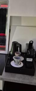 a table with a coffee pot and a cup on it at La maison du soleil in Vitrolles