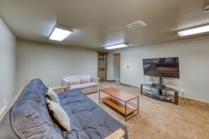 a living room with a couch and a flat screen tv at 615 Oro Grande in Dillon