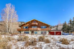 a large house with a deck in the snow at 615 Oro Grande in Dillon
