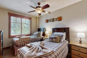 a bedroom with two beds and a ceiling fan at Mountain Thunder 5202 in Breckenridge +47 photos