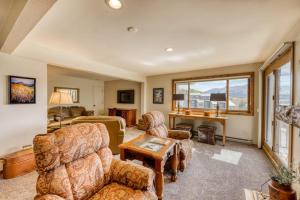 a living room with two chairs and a table at Beautiful Mountain View Condo in Crested Butte