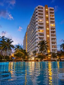 a hotel with a pool in front of a building at View Talay 1B Studio in Pattaya South