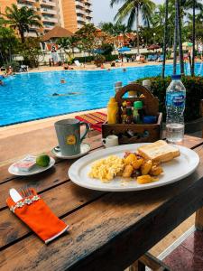 a plate of food on a table next to a pool at View Talay 1B Studio in Pattaya South