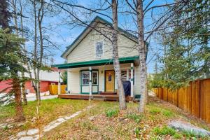 a small white house with a wooden fence at Harris House in Breckenridge