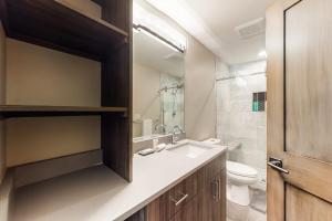 a bathroom with a sink and a toilet at Woodhaven Hideaway in Frisco +79 photos