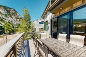 a wooden table and chairs on the balcony of a house at Woodhaven Hideaway in Frisco