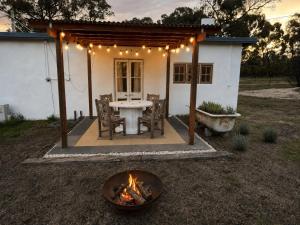 a patio with a table and a fire pit at Little Mykonos right here in Stanthorpe! in Stanthorpe
