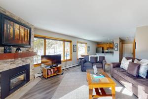 a living room with a couch and a fireplace at Watch Hill 216 in Silverthorne