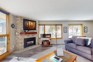 a living room with a couch and a fireplace at Watch Hill 216 in Silverthorne