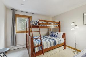 a bedroom with two bunk beds and a lamp at Ore House 8 in Frisco