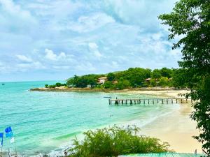 a view of a beach with a dock in the water at Benny Seaview house in Ao Phutsa