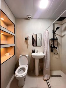 a small bathroom with a toilet and a sink at AL-BUKHARI Boutique Hostel in Bukhara