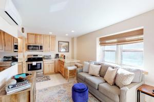 a living room with a couch and a kitchen at Jarvis #202 in Durango