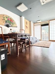 a living room with a table and a couch at 雅 in Kyoto
