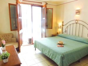 a bedroom with a bed with a hat on it at Hotel Dainzu in Oaxaca City