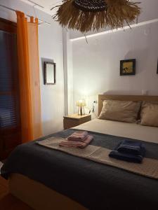 a bedroom with a bed with two towels on it at Aithra House Αίθρα in Toroni
