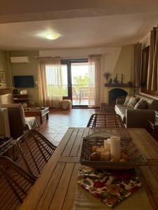 a living room with a table and chairs and a couch at Aithra House Αίθρα in Toroni