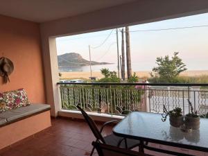 a balcony with a table and a view of the ocean at Aithra House Αίθρα in Toroni